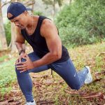 Atleta che si ferma durante l'attività sportiva per un dolore alla gamba